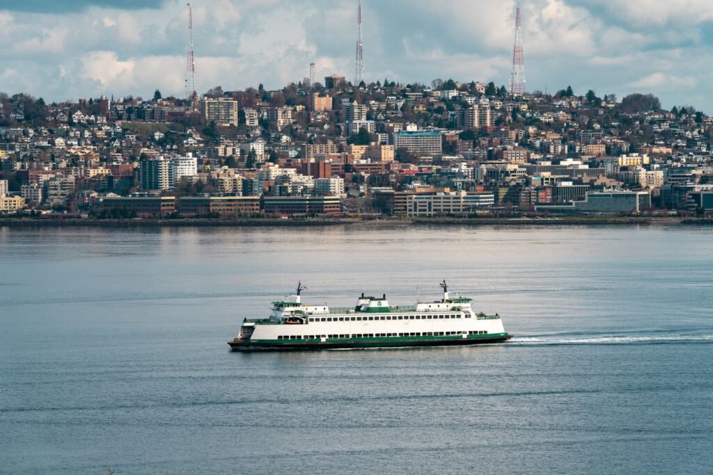 A Washington State Ferry crossing Puget Sound with the Seattle skyline behind it