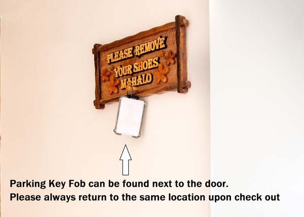 Ilikai 1707 parking key fob hanging below the Please Remove Your Shoes sign next to the front door